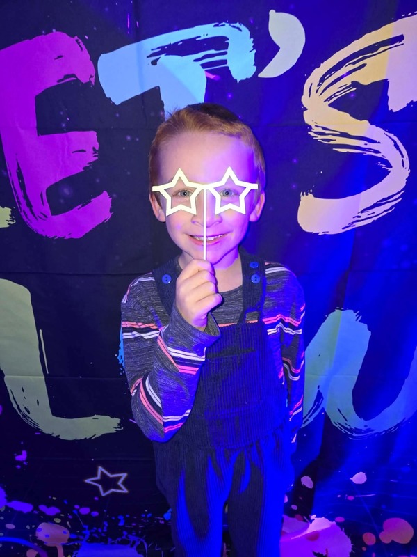 Students in glow party photo booth.