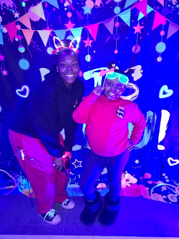 Students in glow party photo booth.