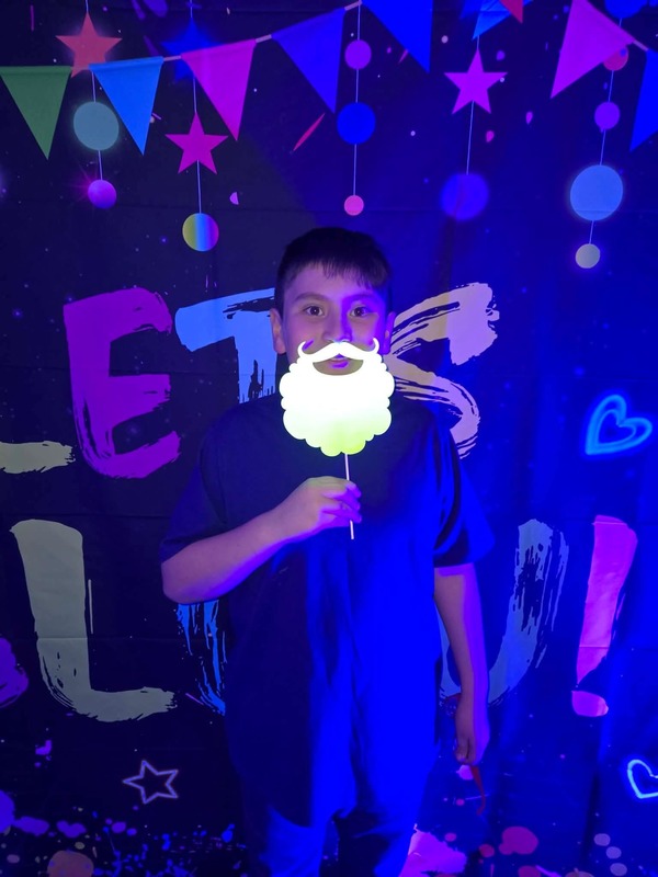 Students in glow party photo booth.