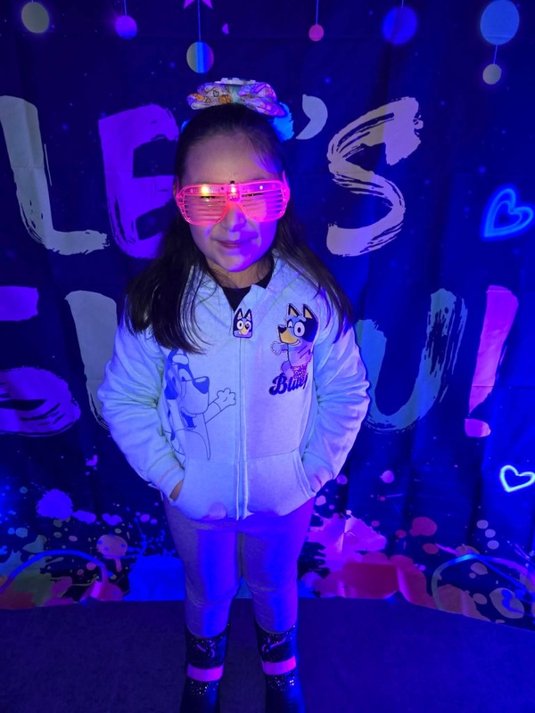Students in glow party photo booth.