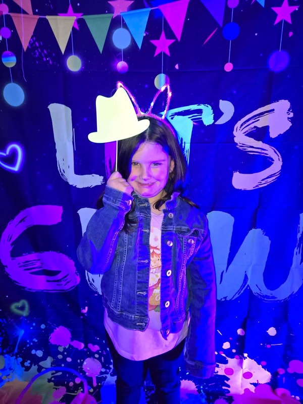 Students in glow party photo booth.