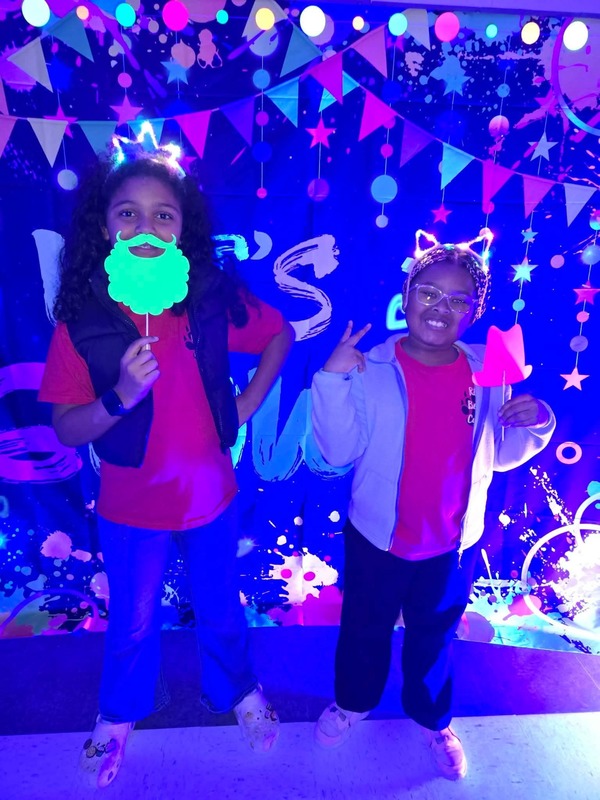 Students in glow party photo booth.