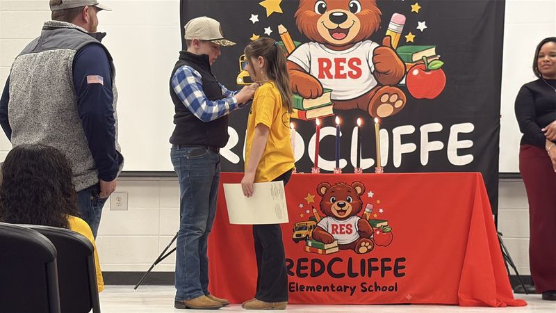 Student being pinned by family.