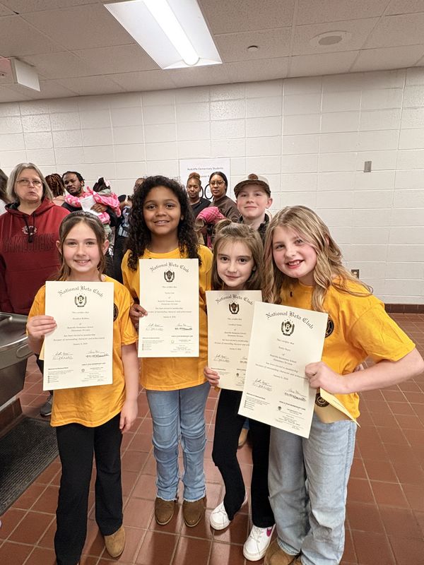 Students holding their certificates.