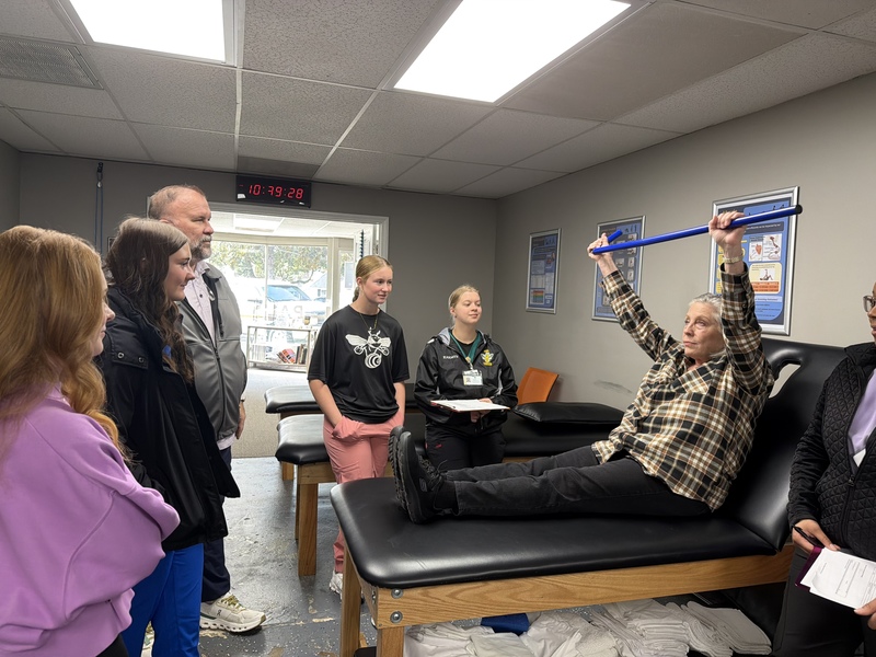 Students observing physical therapy moves.
