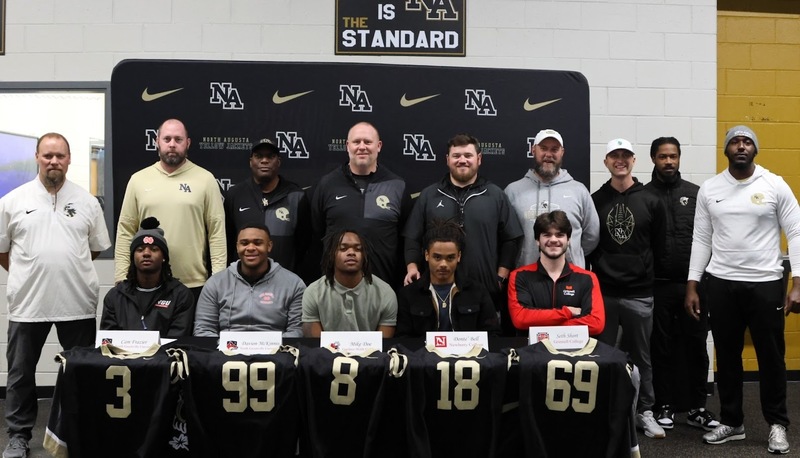 Football players with coaches.