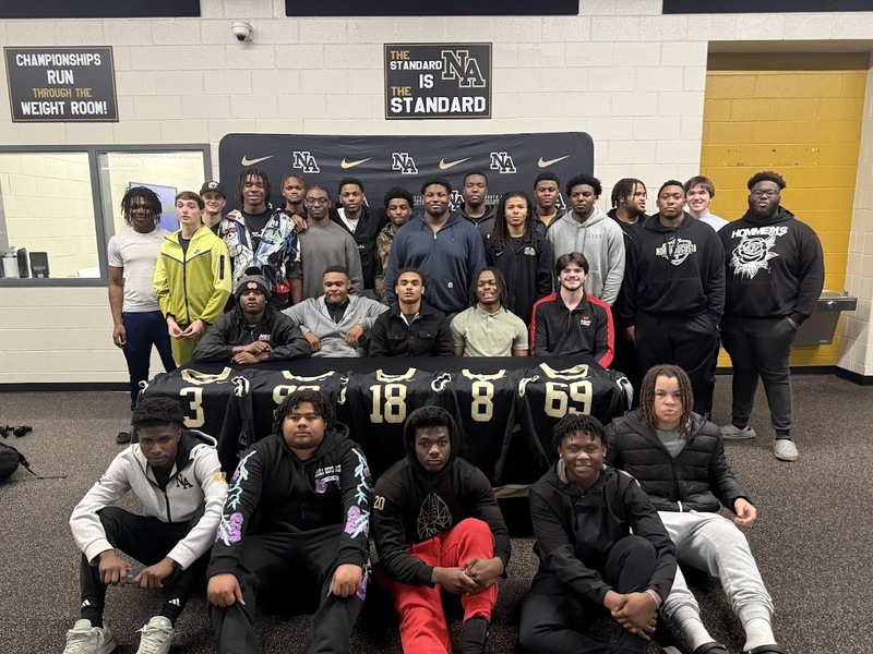 Group of football players posing for a picture.