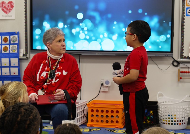 Christine Witt speaks with her students.