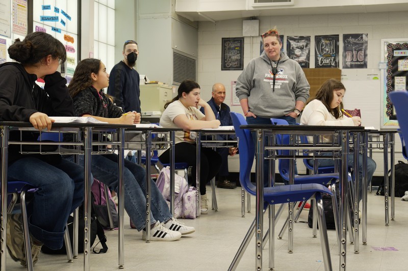 Heather Parliament walks around the classroom.