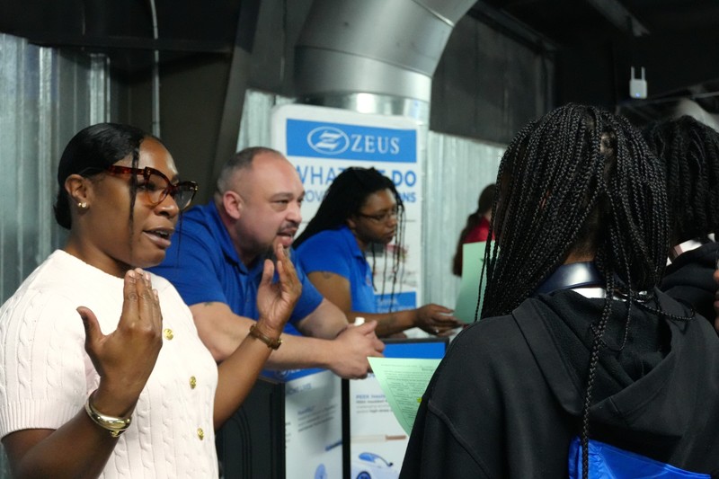 Industry representative speaking to a student.