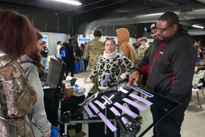 Students and instructors observing something at the Power Up event.