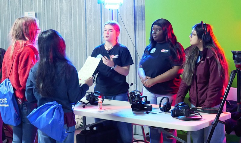 Media instructors talking to students.