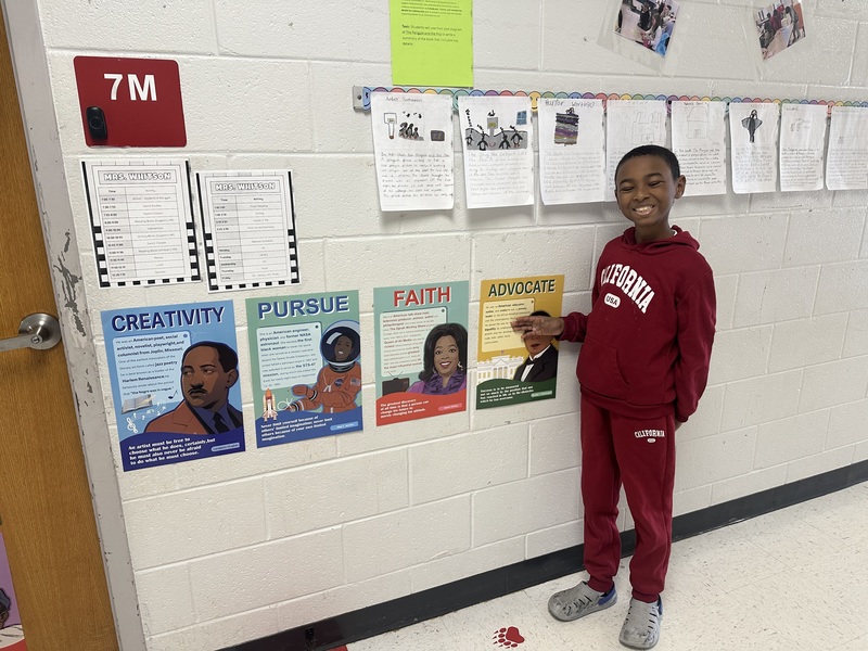 Student with work displayed.