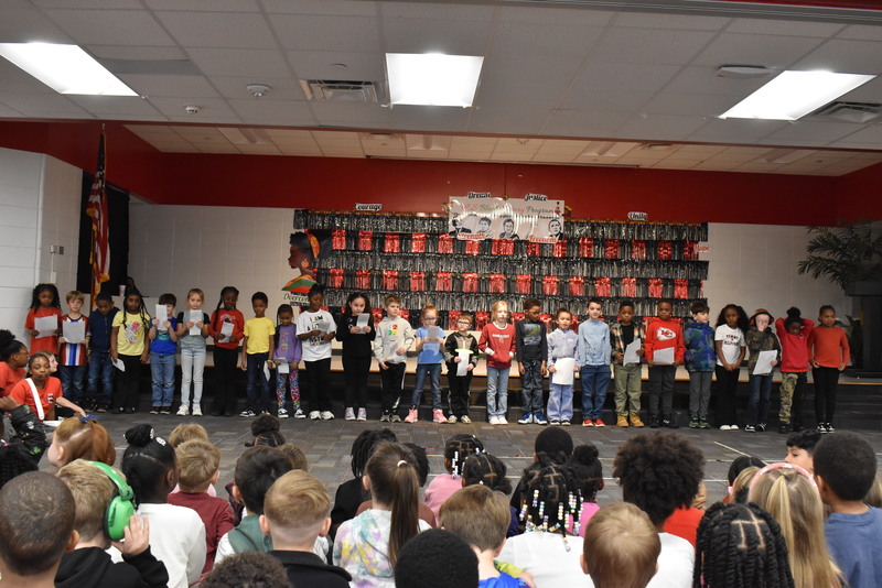 1st grade students performing on stage.