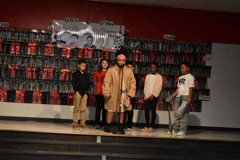 4th and 5th grade students performing on stage.