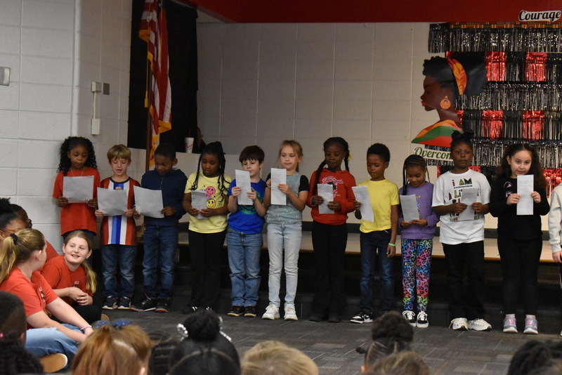 1st grade students performing on stage.