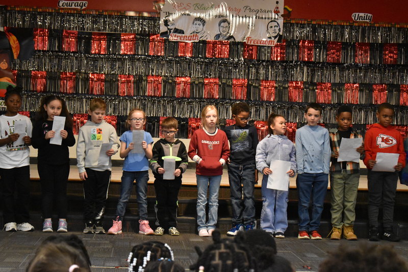 1st grade students performing on stage.