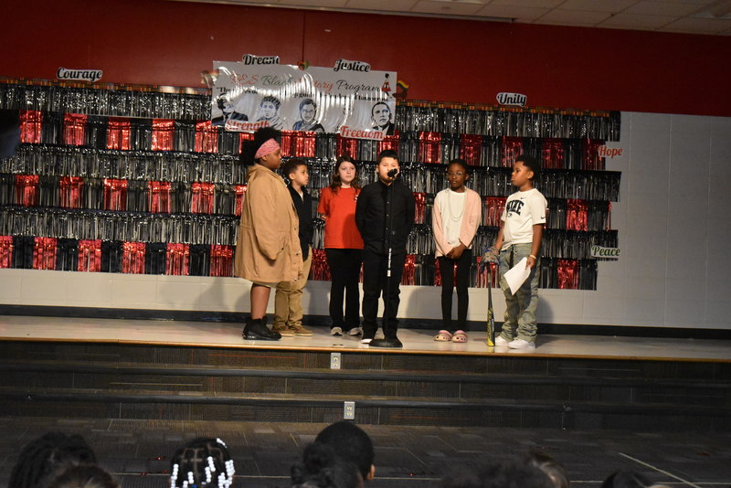 4th and 5th grade students performing on stage.