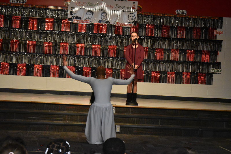 Student singing and student dancing on stage.