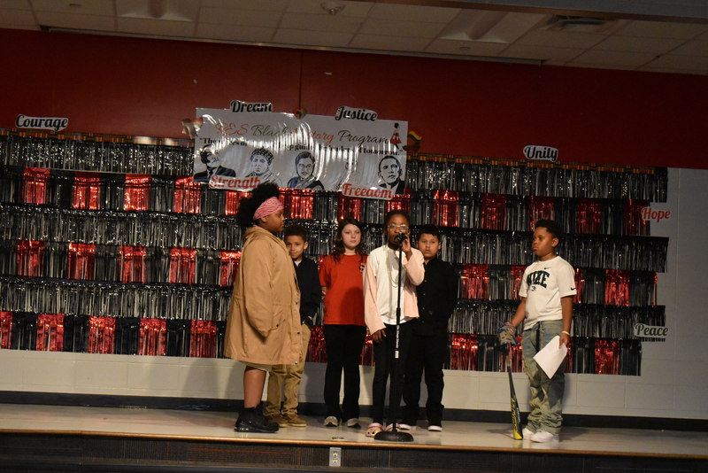 4th and 5th grade students performing on stage.