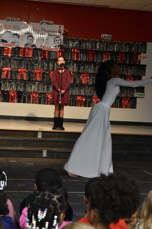 Student singing and student dancing on stage.