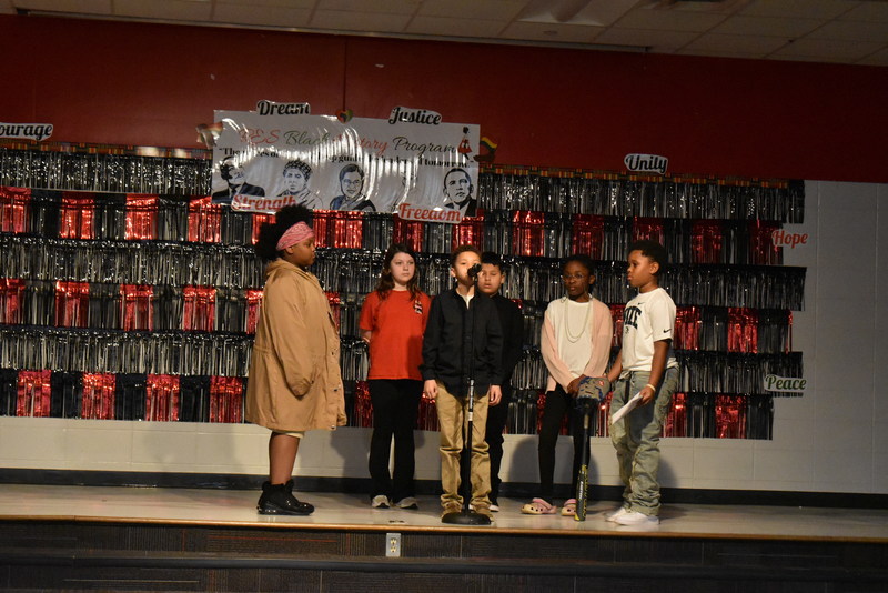 4th and 5th grade students performing on stage.