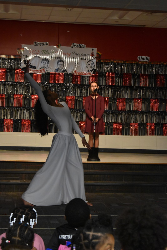 Student singing and student dancing on stage.