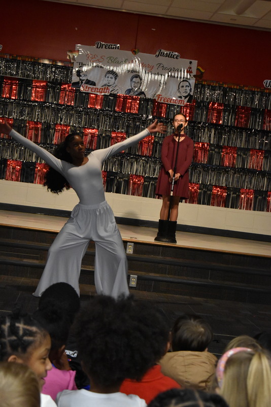 Student singing and student dancing on stage.