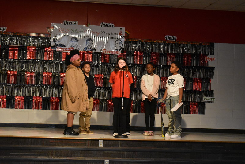 4th and 5th grade students performing on stage.