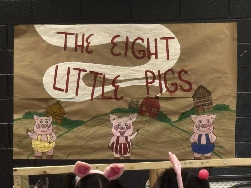 Backdrop for the play saying ""The Eight Little Pigs."