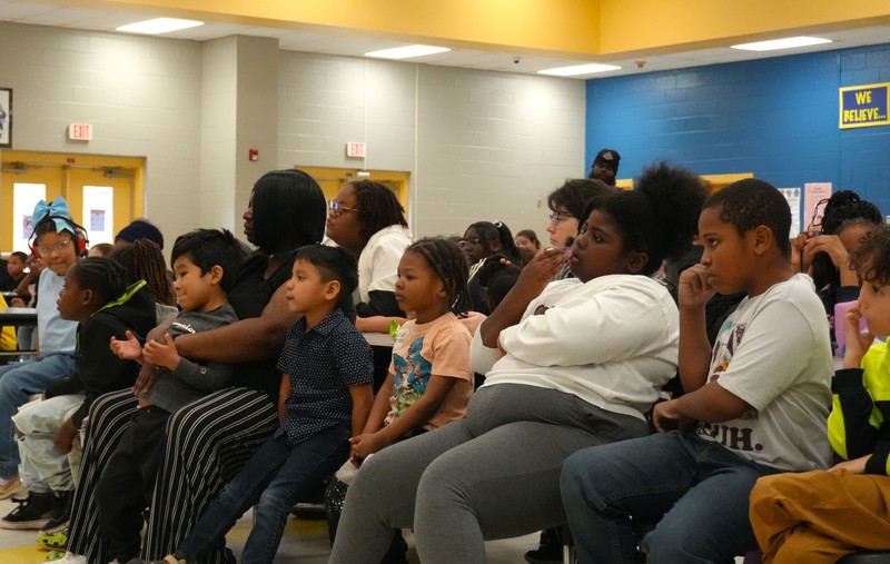 Students listen and participate during the Black History Month event.