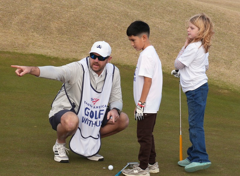 Instructor points off camera while speaking with students.