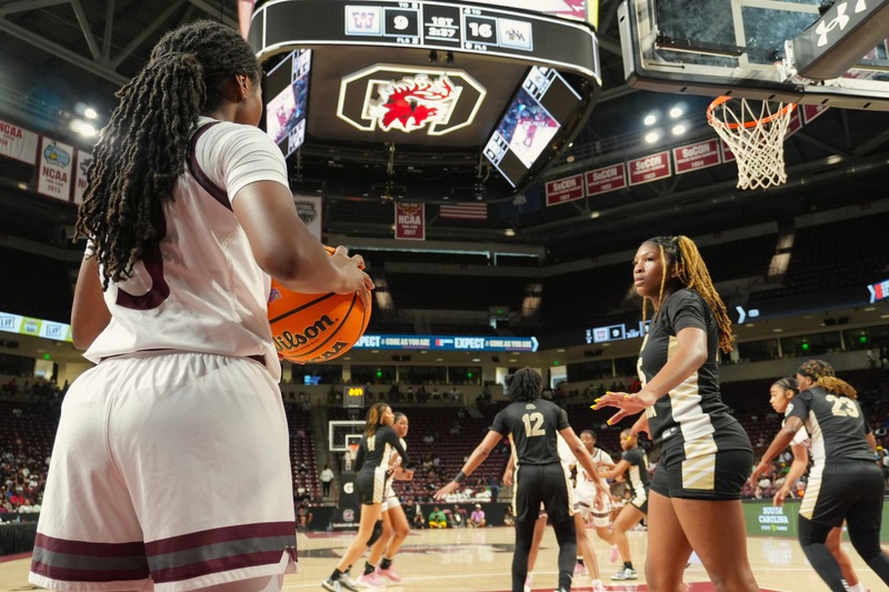 North Augusta Girls basketball waits to block basketball against Westside player.