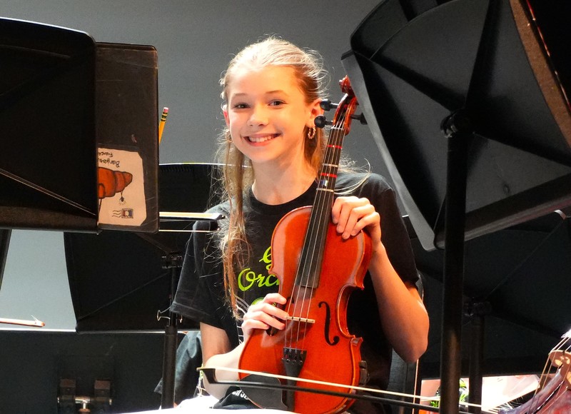 Student Claire Rigby holds up viola instrument.
