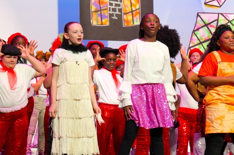 Two students on stage mid performance.