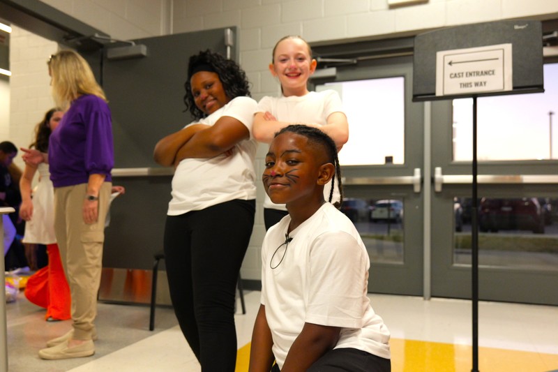 Lead actor Anthony Patterson poses for a photo backstage with two of his costars.