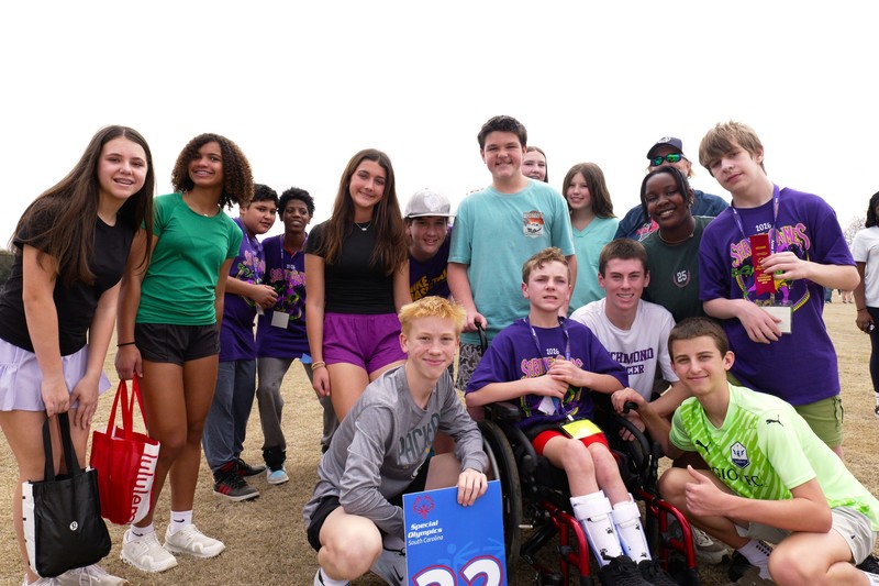 Group smiles at Special Olympics.