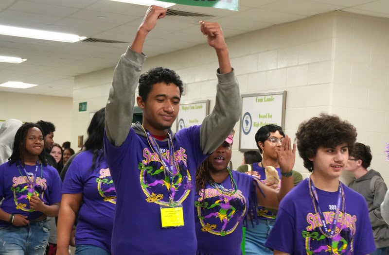 Student raises his arms prior to Special Olympics.