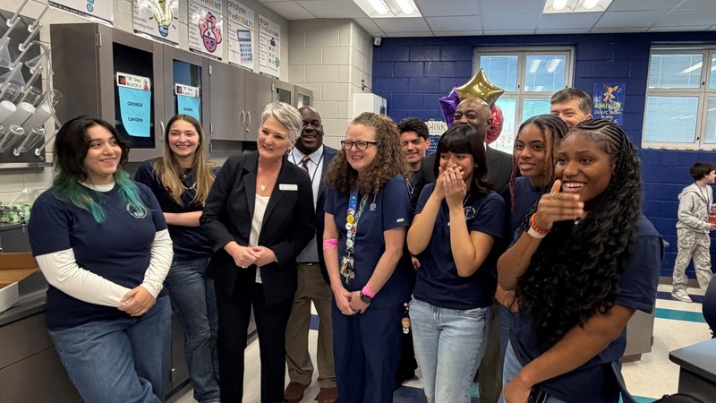 ACPSD students and staff surrounding Dr. Palladino as she is being honored.