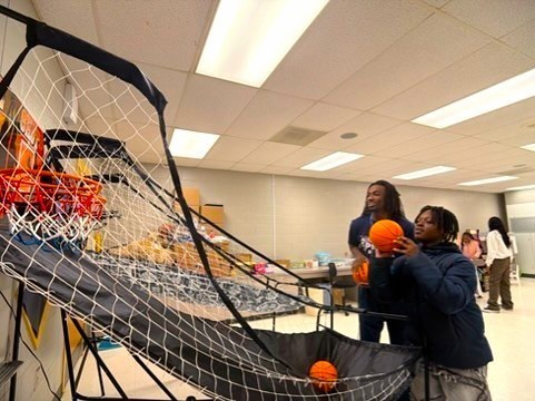 Howard student shooting indoor basketball.