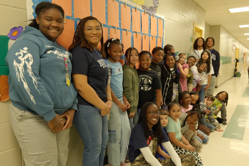 Howard students and East Aiken students pose for photo in hallway.