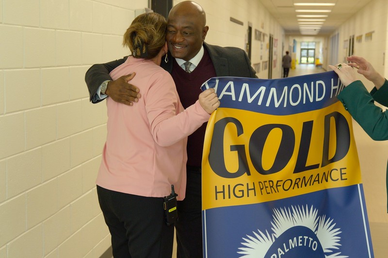 Hammond Hill principal hugs ACPSD Superintendent.