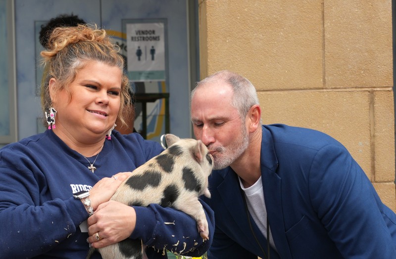 Principal of Ridge Spring participates in Kiss the Pig.