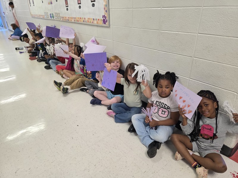 Students in hall with signs and streamers for parade.