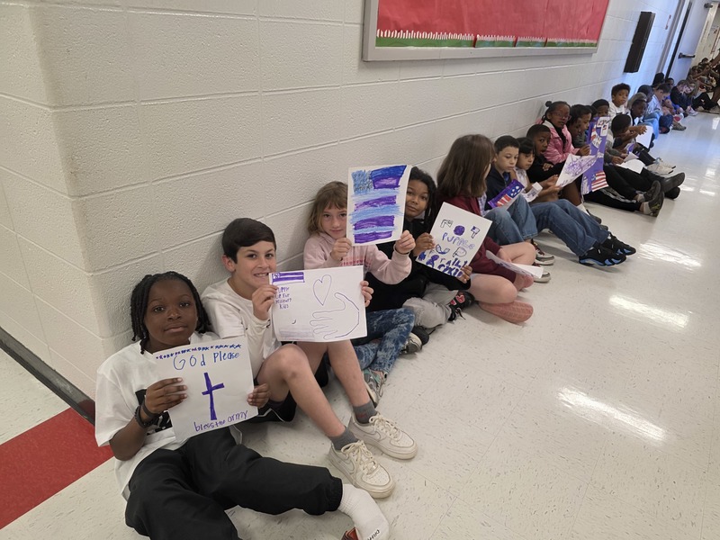 Students in hall with signs and streamers for parade.