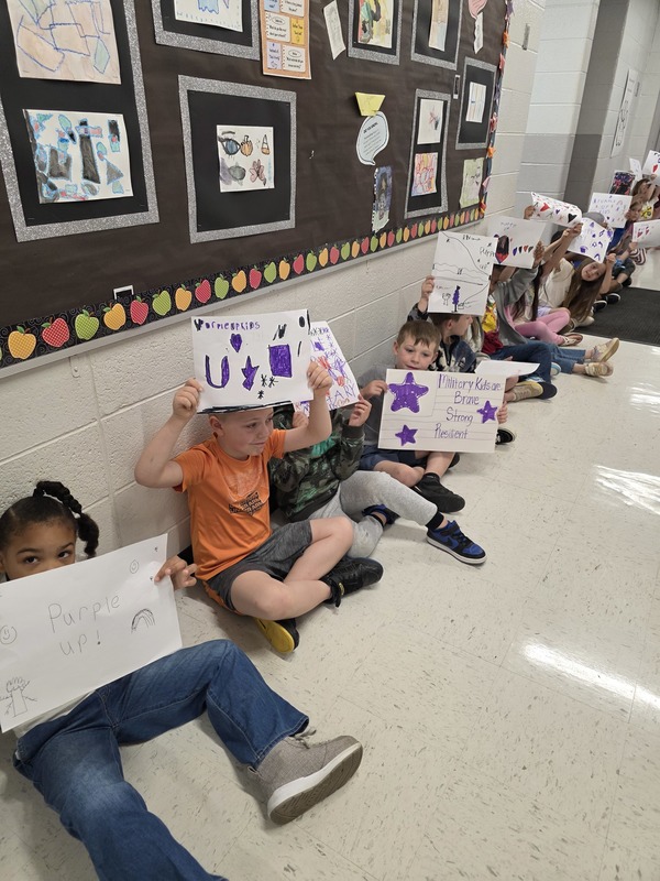 Students in hall with signs and streamers for parade.