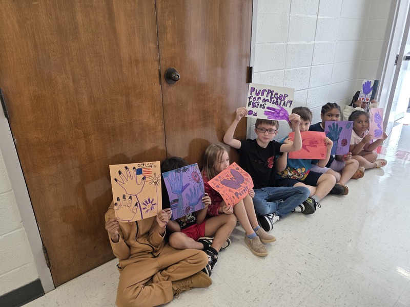 Students in hall with signs and streamers for parade.