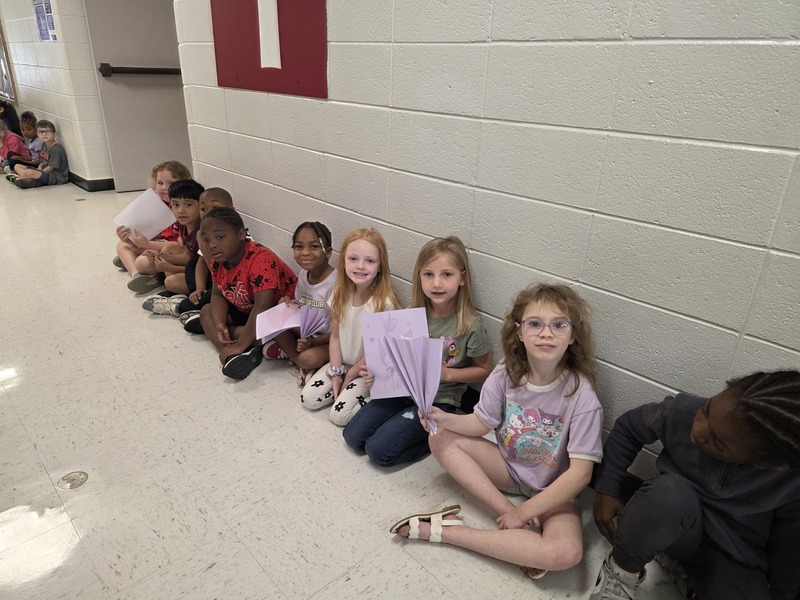 Students in hall with signs and streamers for parade.
