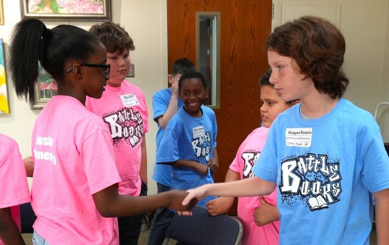 Elementary school students shake hands in sportsmanship following Battle of the Books.