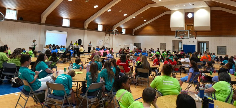 Elementary students watch final book battle for the trophy and bragging rights. 